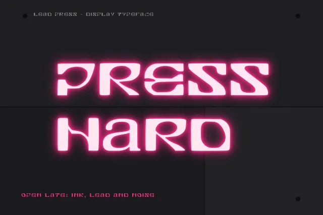 Lead Press neon style card with the words Press Hard glowing pink on a dark grey wall and a small caption line