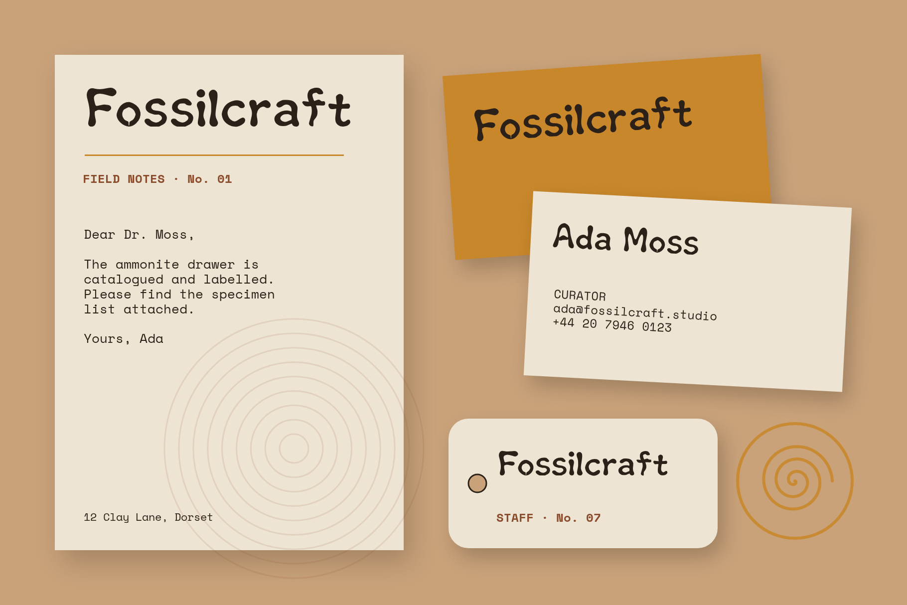 Fossilcraft brand identity with a field notes letterhead, two business cards and a staff tag in brown and amber