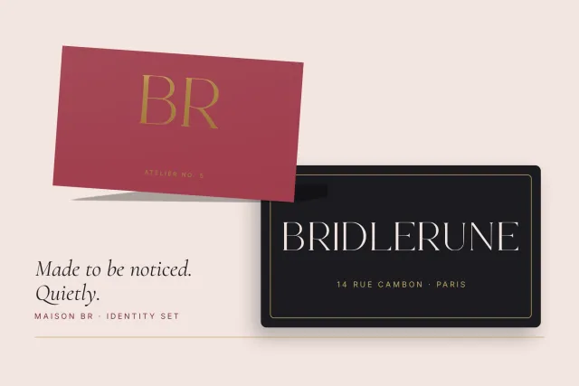 BridleRune identity set with a gold BR monogram on a burgundy card and a black business card